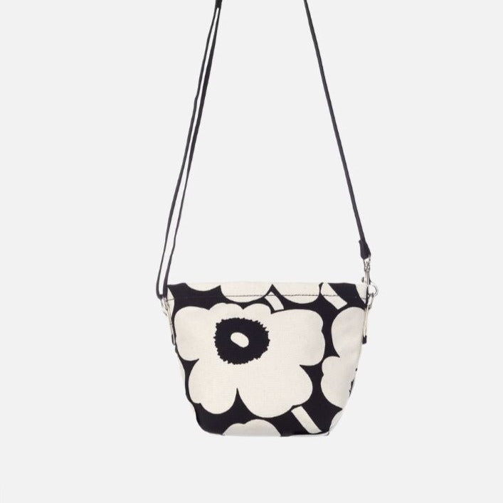 Marimekko Mono Mini Crossbody purse The Mono Mini Crossbody is made of unbleached organic cotton, which features the Unikko pattern printed in Helsinki. The shoulder bag has a zipper closure, an open pocket on the outside, and an adjustable shoulder strap.