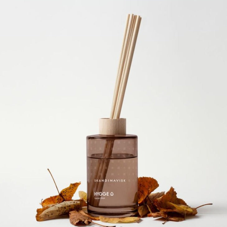 Skandinavisk Scent Diffuser-Hygge 200ml  The new Skandinavisk diffuser collection blends Scandinavian fragrance stories with renewably farmed vegetable oils inside a painted glass vase, with decorative FSC-certified beechwood ring, and eight high-performance reeds for up to 3 months of gentle and responsible room fragrance.